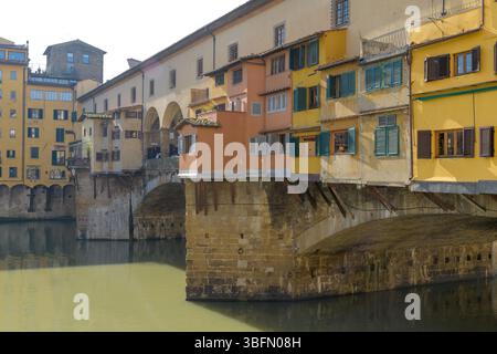 Close-up view of Ponte Vecchio with traditional shops and Vasari Corridor above the Arno River in Florence, Italy, showcasing medieval architecture. Stock Photo