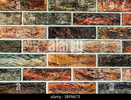 Colorful Brick Wall Texture: Artistic and Vibrant Background for Creative Projects. The bold colors and rough surface provide a dynamic urban feel, making it ideal for modern and abstract. Stock Photo