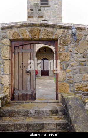 stone wall with open medieval door on background another blurred door closed, Gomionica Monastery, Kmecani, Bosnia and Herzegovina Stock Photo