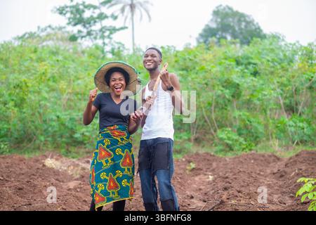 excited african farmers checking a phone together Stock Photo
