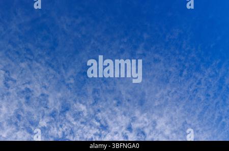 High altitude wispy white cirrocumulus clouds on blue sky, Finland Stock Photo