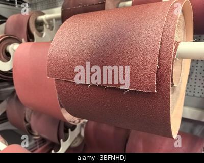 A collection of rich brown sandpaper rolls displayed in a workshop. The texture and quality promise effective sanding for various crafting tasks. Idea Stock Photo
