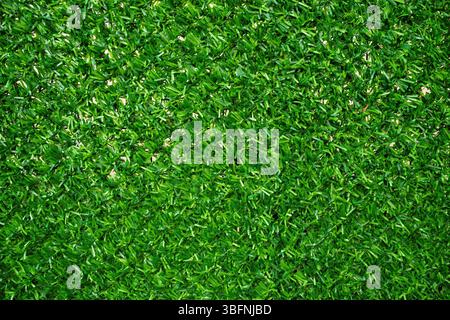 Texture of artificial green grass fencing material as background, closeup Stock Photo