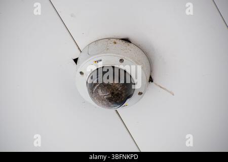 Orem, Utah – June 2, 2025. A ceiling-mounted security camera used for outdoor surveillance and monitoring in a commercial or public space. Stock Photo