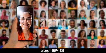 A hand holds a smartphone displaying facial recognition software Stock Photo