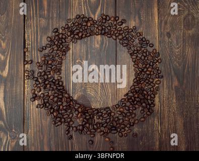 Round frame of Coffee beans on wooden background, top view, copyspace Stock Photo