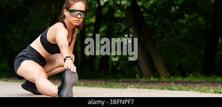 Modern fit woman doing warm-up exercise before street workout Stock Photo