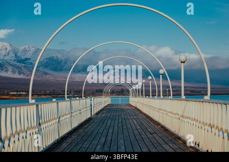 Pier with wooden floor on lake on autumn day Stock Photo