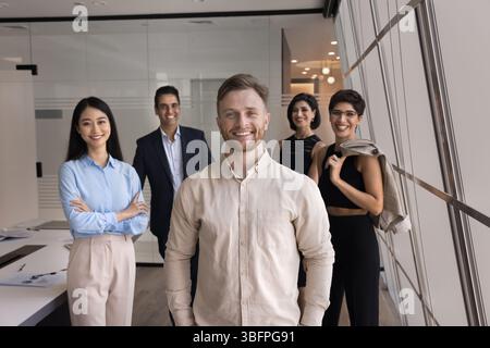 Portrait of five corporate staff members posing in office Stock Photo