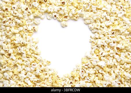 Heart made of crispy popcorn on white background Stock Photo