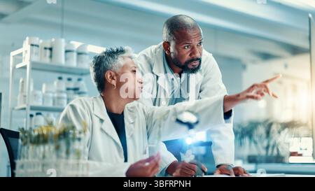 Biology, computer and pointing with science people in laboratory for breakthrough or development. Collaboration, healthcare and innovation with Stock Photo