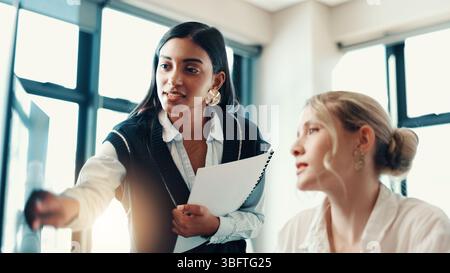 Business women, coaching or computer with help for assistance, project or guide at office. Female people, employees or training staff on technology Stock Photo