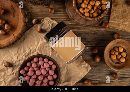 Bowl of raspberry taste white chocolate covered peanuts with blank label jar in background Stock Photo