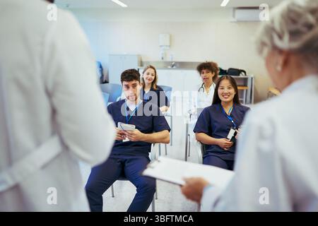Medical team attending conference in modern hospital setting Stock Photo