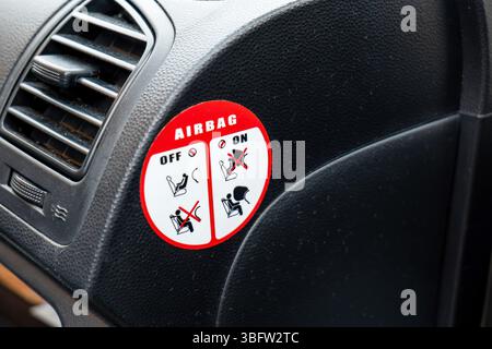Closeup of an airbag instructions sticker, air bag safety practices symbol guide for a child seat and passenger protection interior vehicle warning la Stock Photo