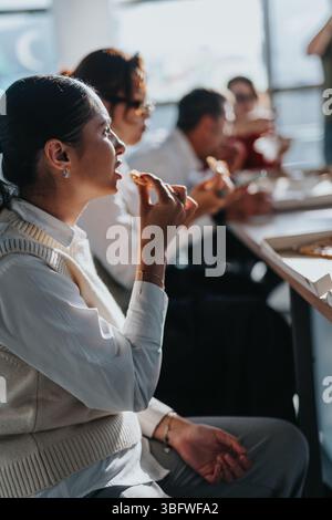 Multicultural business group enjoying pizza lunch together at office Stock Photo
