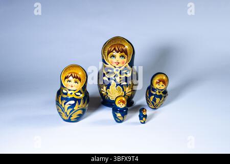 Set of five traditional Russian nesting dolls on a clean white background. Stock Photo