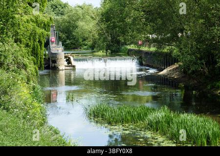 Melksham a small town in wiltshire UK The Weir on the River Avon next to the old Avon or Coopers Tyres Factory. Stock Photo