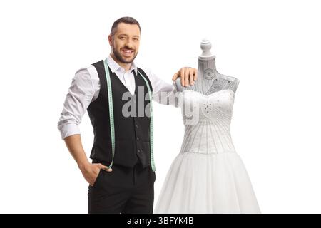 Tailor standing next to a bridal gown isolated on white background Stock Photo