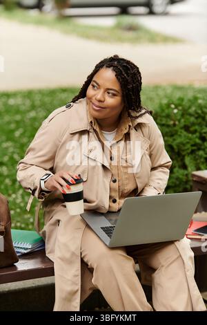 University educator enjoys a moment outdoors, collaborating with students on laptop projects. Stock Photo