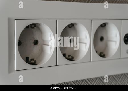 Triple European Electrical Wall Socket Close-Up in Modern Interior Stock Photo