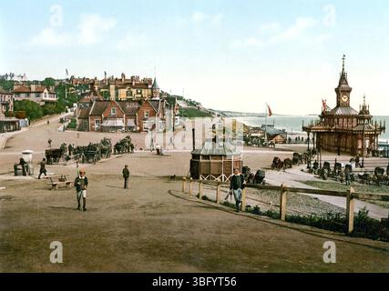 Bournemouth Pier, Dorset, England, Colourised historic photograph of showing Victorian-era seaside architecture and crowds on the pier and beach Stock Photo