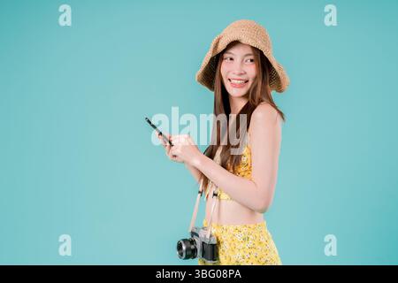 Asian Woman using smartphone for booking and buying ticket Online, Young Woman Holding a Mobile Stock Photo