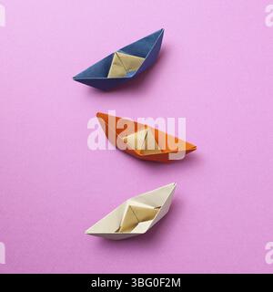 Paper ship on pink background Stock Photo