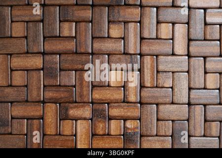 Close-up of the intricate texture made of dark, wooden slabs creating square shapes Stock Photo