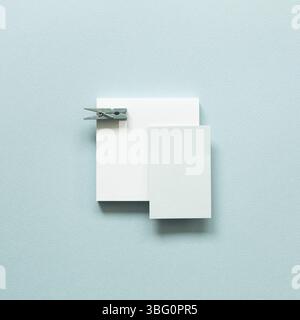 Blue memo pad with wooden clip on blue background. top view, copy space Stock Photo