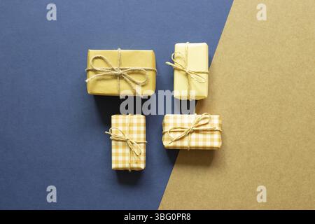 Yellow gift boxes on blue and brown background. flat lay, top view, copy space Stock Photo