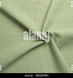 Crumpled natural green fabric texture background Stock Photo