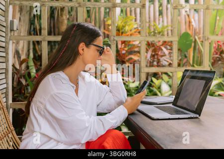 Business woman working on laptop computer in cafe Stock Photo