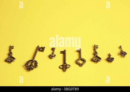 Different keys on yellow background. Choice and right solution concept Stock Photo