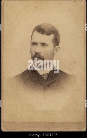 William Northrup Moore is seen wearing a sack suit with a striped tie and moustache. He was born in Ohio in 1856 and passed away in Kansas in 1932. Moore worked in various cities, including Kansas City, where he organized a gas company. The photograph was taken by James Madison Elliott. Stock Photo