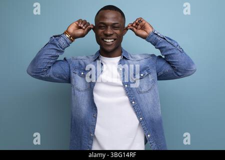 Handsome confused young attractive african man dressed casually in denim Stock Photo