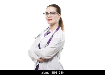 Beautiful happy cheerful woman doctor looking in camera waiting for a patient confident successful smiling with stethoscope with arms crossed Stock Photo