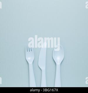 Fork knife spoon on sky blue background. flat lay, top view, copy space Stock Photo