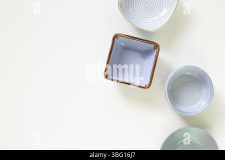 Colorful empty plates on white background. flat lay, top view, copy space Stock Photo