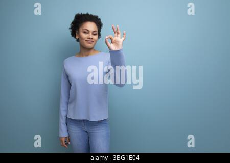 Portrait latina brunette woman with wavy hair in blue stylish casual clothes Stock Photo