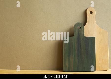 Wooden tray, cutting board, plate on wooden table with brown background Stock Photo