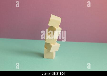 Stack of makeup sponge on mint green table. pink wall background Stock Photo