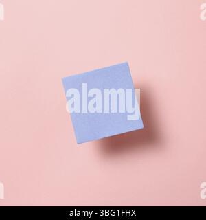 Blue memo pad, sticky note on pink background Stock Photo