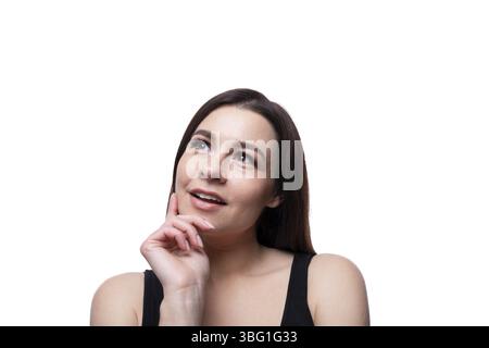 Casual young brunette woman daydreaming Stock Photo