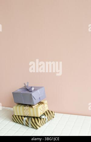 Colorful gift boxes on white table. pink wall background Stock Photo