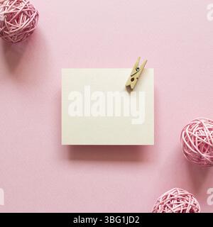 Blank memo pad with wooden clip on pink background. top view, copy space Stock Photo