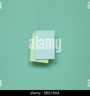 Blue memo paper, sticky notes on mint green background. top view, copy space Stock Photo