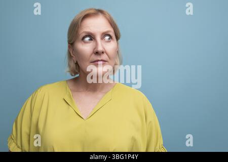 Portrait of surprised middle aged blond woman with bob hairstyle Stock Photo