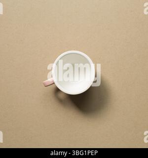 Empty mug cup on brown background Stock Photo