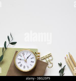Notebook, pencil, clip, clock on white background. flat lay, top view, copy space Stock Photo
